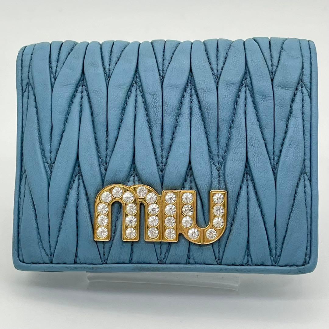 ミュウミュウ 二つ折り財布 マテラッセ クリスタル ビジュー ロゴ金具 レザー