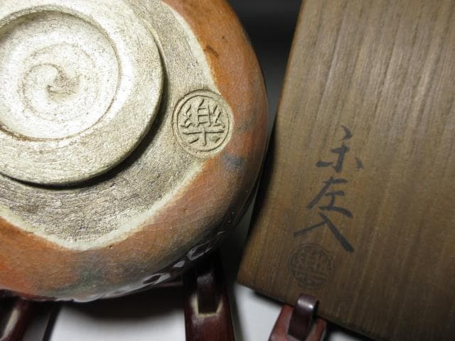 楽吉左衛門六代 左入 赤茶碗／楽吉左衛門九代 了入 書付在り／共箱 仕覆付き