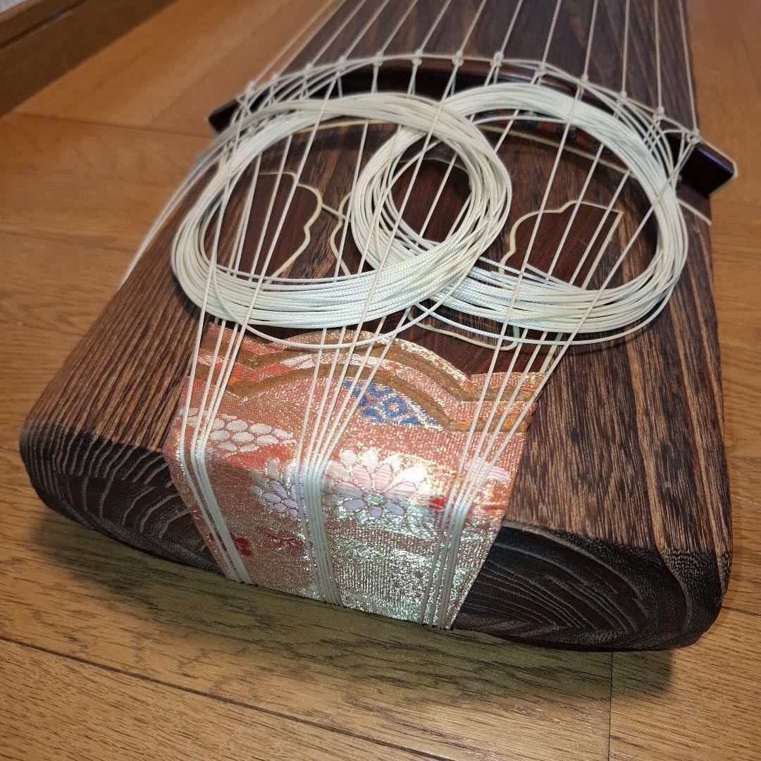 オレンジ色の鶴模様の袋つき　　　お琴