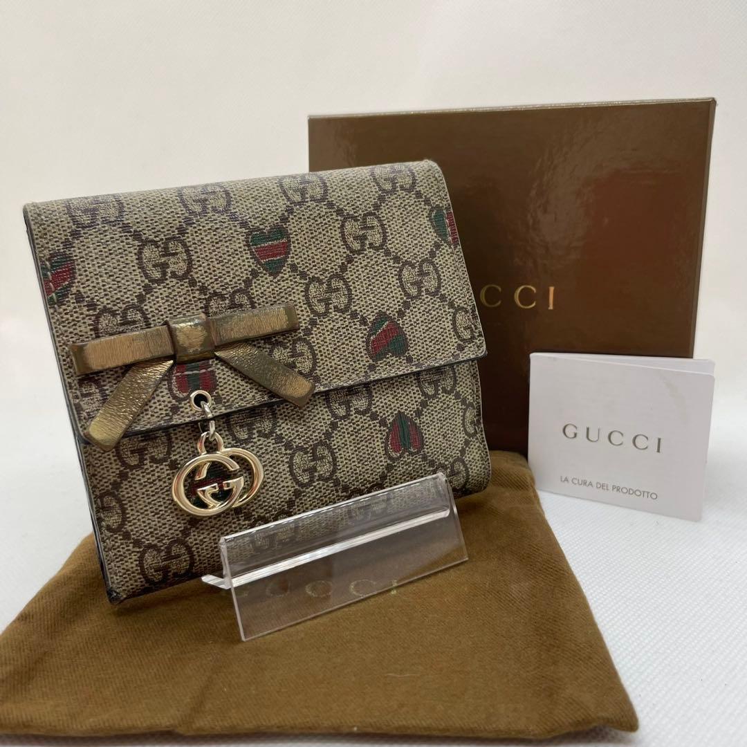 【美品/付属品完備】グッチ 二つ折り財布 小銭 GGシマ リボン ロゴチャーム