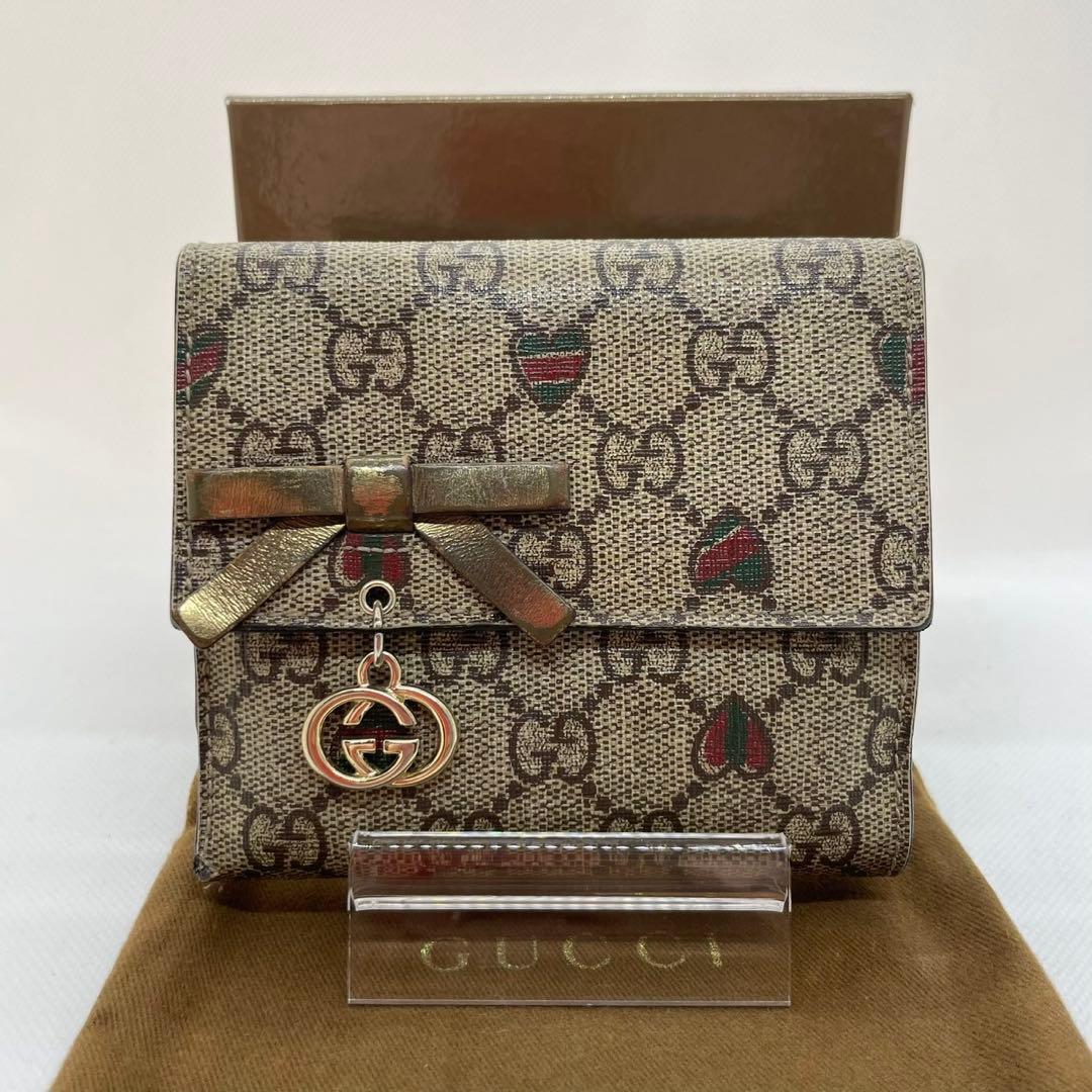 【美品/付属品完備】グッチ 二つ折り財布 小銭 GGシマ リボン ロゴチャーム