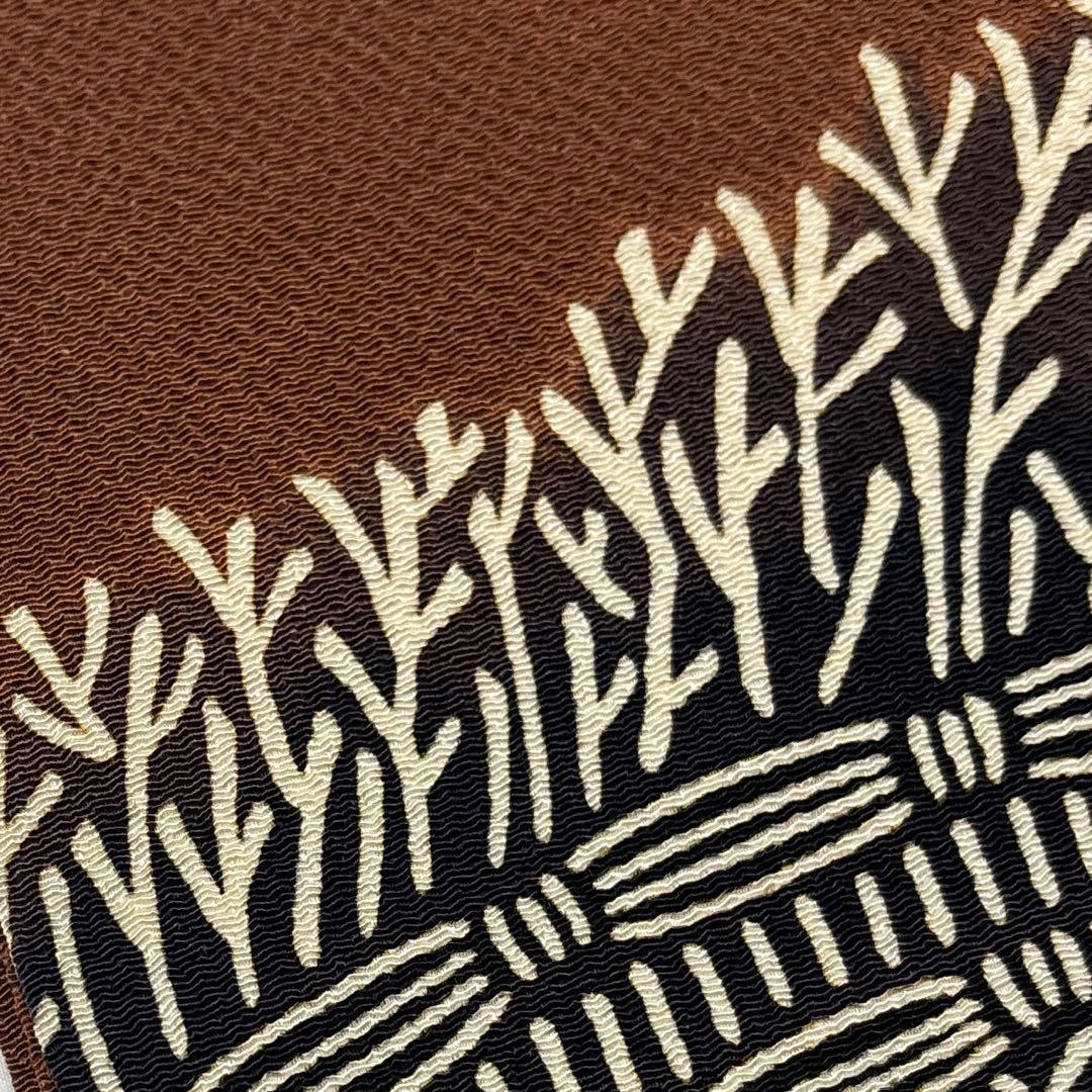 開き名古屋帯【栗山吉三郎】和染紅型 縮緬 垣根文様 茶色 お太鼓柄 正絹 九寸帯